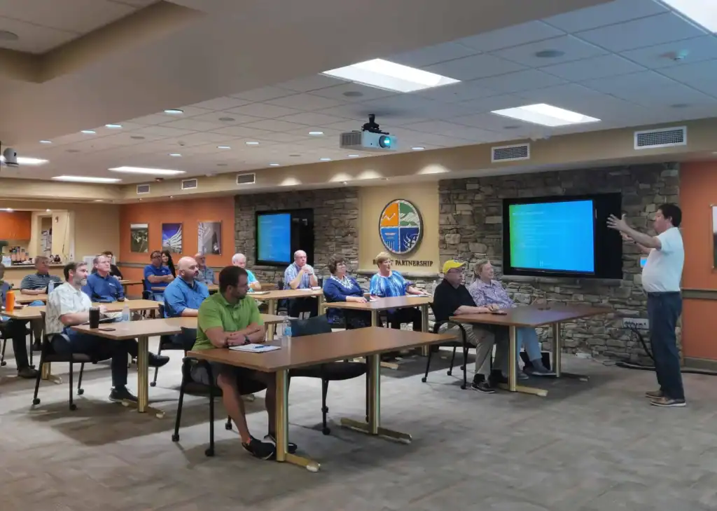 Training session with attendees listening to instructor in a conference room.