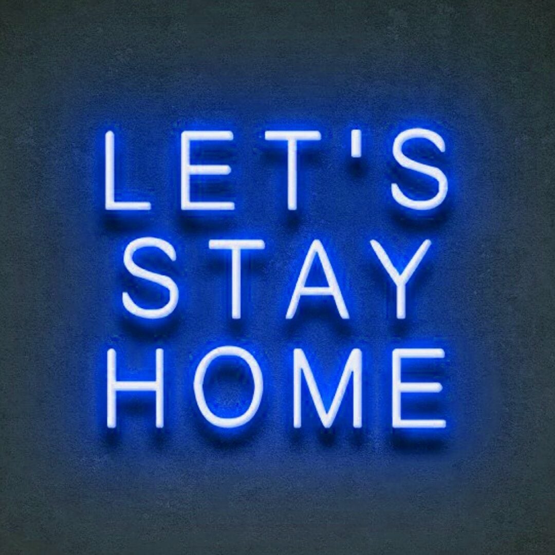 Let's stay home in blue neon sign on dark wall.