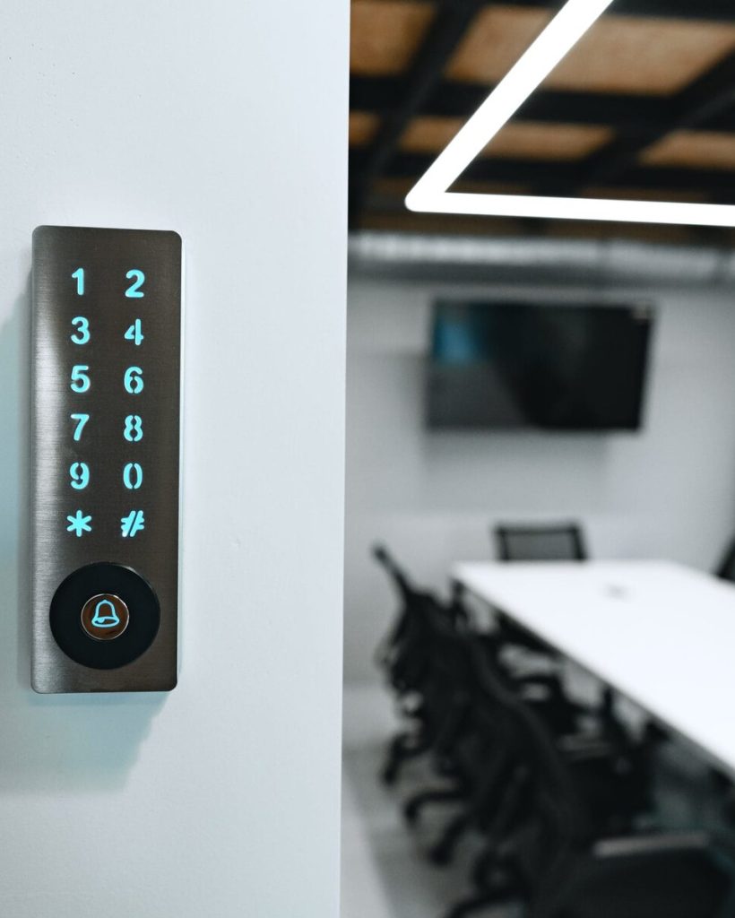 Electronic digital door lock on white office wall close up