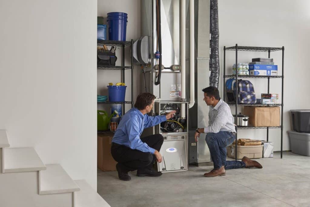 a man showing another man the inside of a furnace