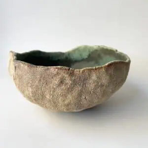 handmade wabi sabi ceramic bowl. Textured stoneware on the outside and turquoise on the inside.