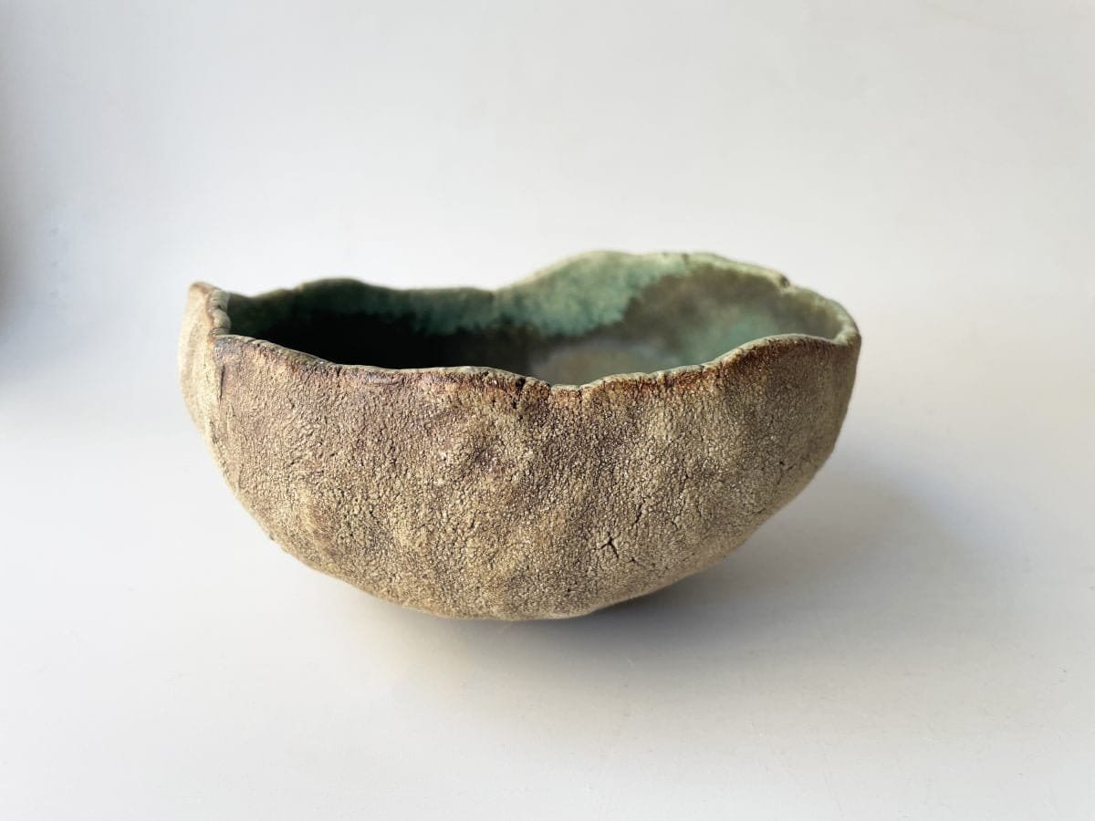 handmade wabi sabi ceramic bowl. Textured stoneware on the outside and turquoise on the inside.