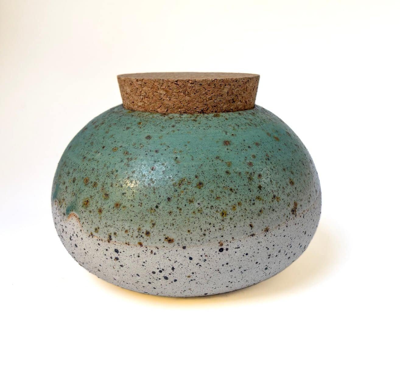 Handmade turquoise stoneware ceramic canister with a natural cork lid, wheel-thrown and finished with a speckled glaze.