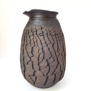 Dark handmade stoneware vase with natural cracked texture, organic rim and minimalist finish by Amelia Johannsen