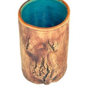Handmade stoneware vessel with a central fractured copper surface and a bright turquoise glazed interior from the Faultline collection.