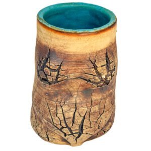 Handmade stoneware vessel with warm copper surface, natural crack patterns and a turquoise glazed interior from the Faultline collection.