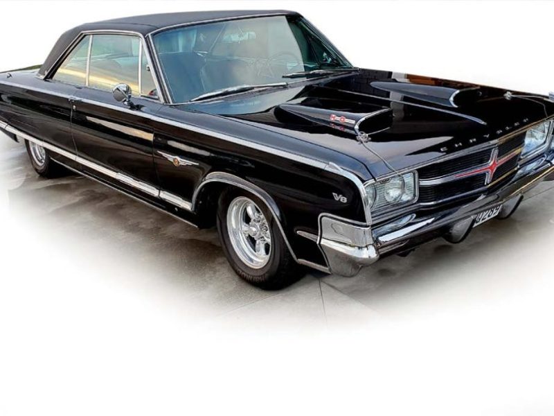 Vintage black muscle car with custom features at American car show.