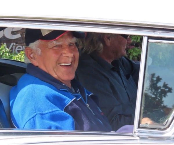 Classic car enthusiasts enjoying a ride at Americarna event in New Zealand.
