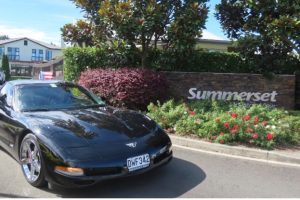 Summerset Resthome 8 Black Chevrolet Corvette sports car parked outside Summerset, showcasing classic American muscle cars.