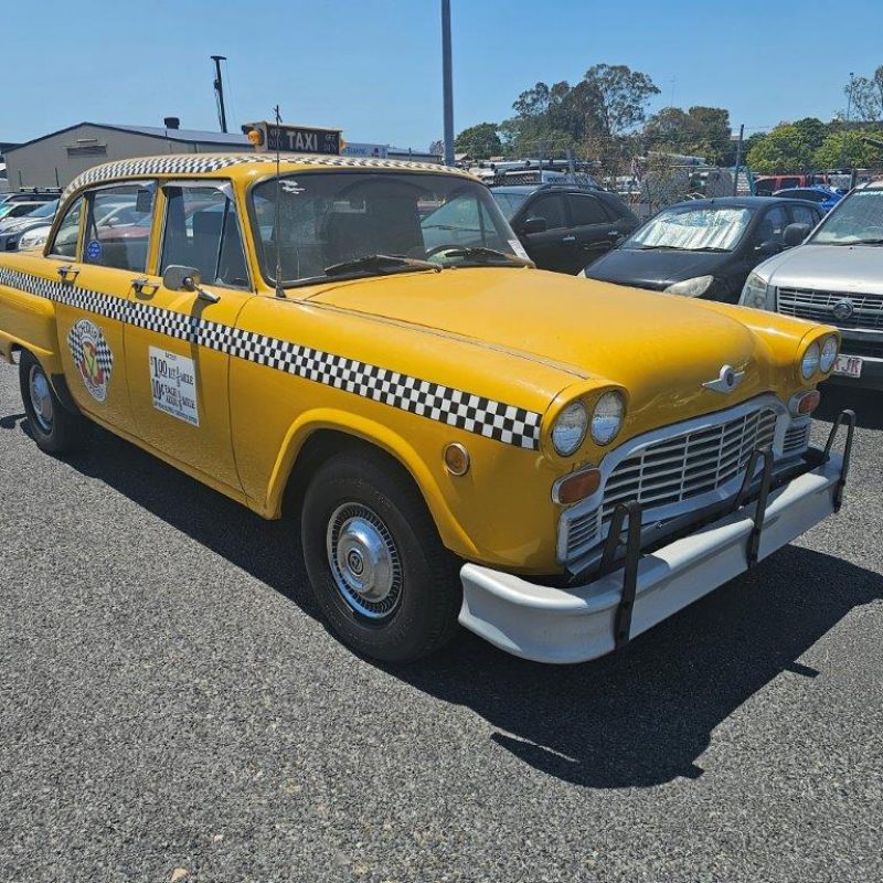 82 Checker Motors Taxi Yellow vintage taxi car at Americarna event in NZ, classic American car, retro taxi in lively yellow colour.