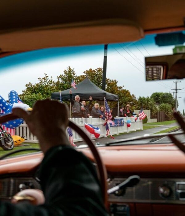Vibrant American car parade with patriotic decorations and motorcycles celebrating USA unity.
