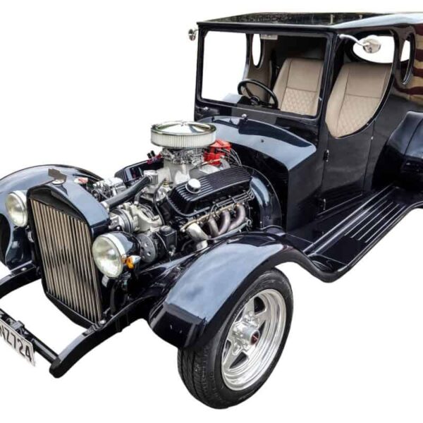 Vintage black classic car with exposed engine at Americarna event in New Zealand.