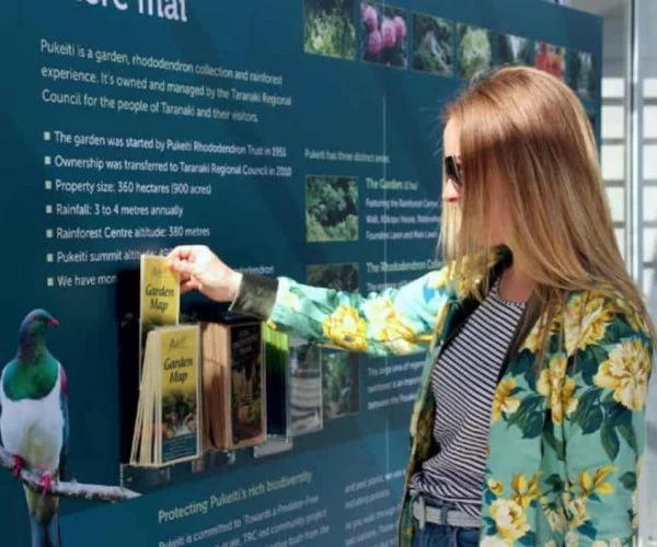 Bird at Puketi rainforest informational display in New Zealand.
