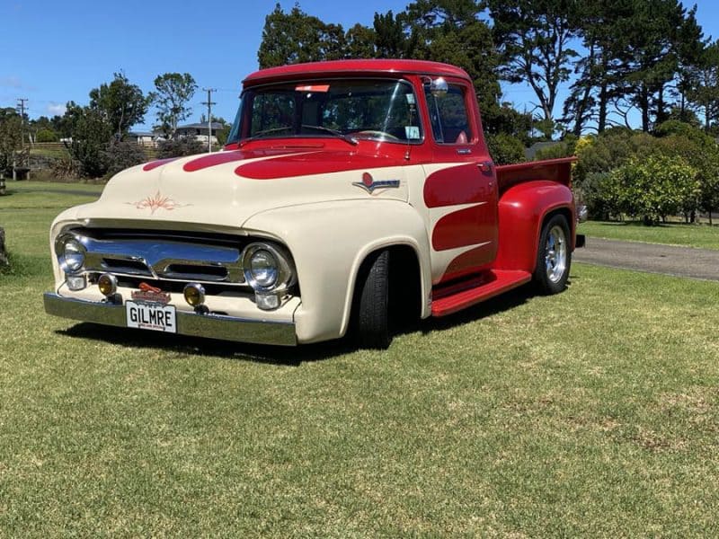 Classic American pickup with custom red and cream styling at Americarna Car Show in New Zealand.