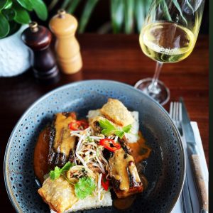 Delicious fish and seafood meal served with a glass of white wine, perfect for a dining experience.