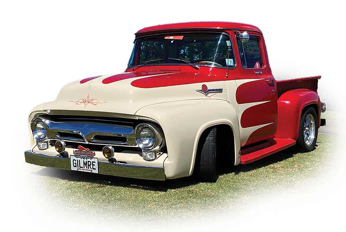 Vintage American muscle car with red and cream paint, chrome details, and custom design.