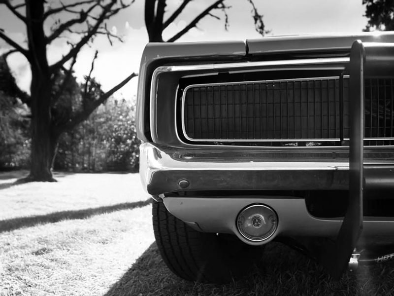 Detailed close-up of a vintage American car's front end showcasing iconic design.