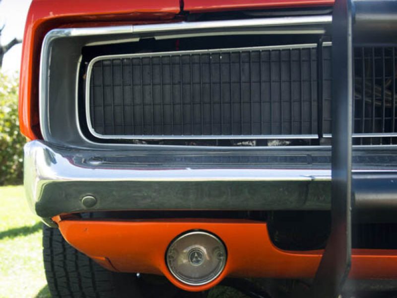 Classic red and black muscle car front close-up.