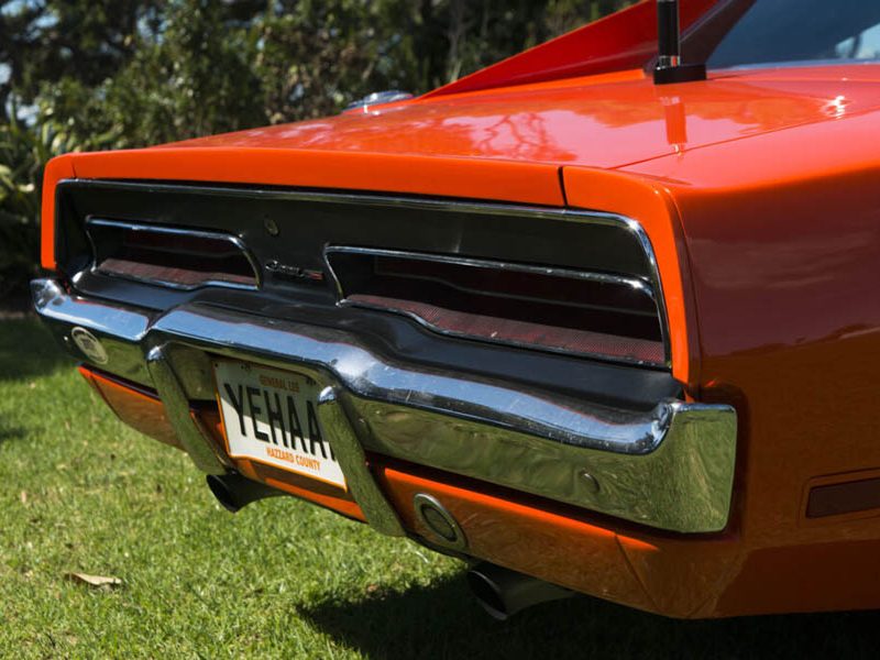 Bright orange vintage car showcasing iconic design at Americarna event.