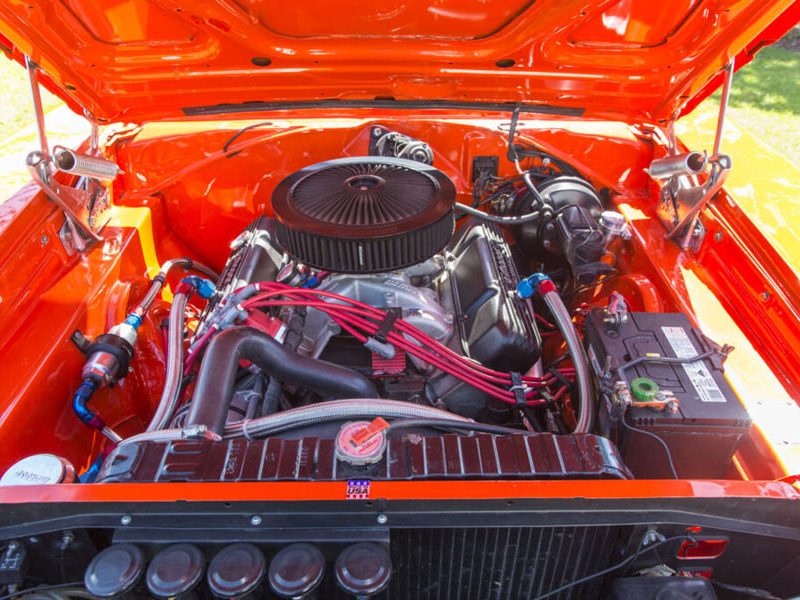 High-resolution close-up of a classic American car V8 engine with vibrant orange paint. Perfect for auto enthusiasts.