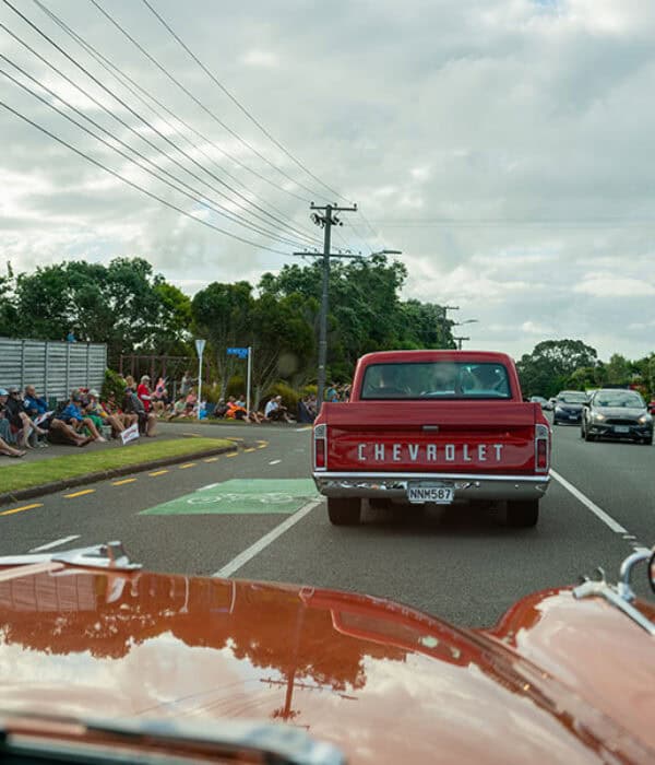 Vintage Chevrolet pickup truck on a parade route in New Zealand.