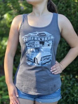 A woman wearing a grey tank top featuring a vintage American car design, perfect for car enthusiasts and summer events.