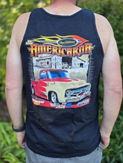 Close-up of a person wearing a sleeveless Americarna T-shirt with a vintage car graphic and event branding.