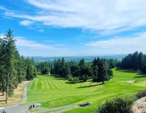 Lush green golf course under blue sky