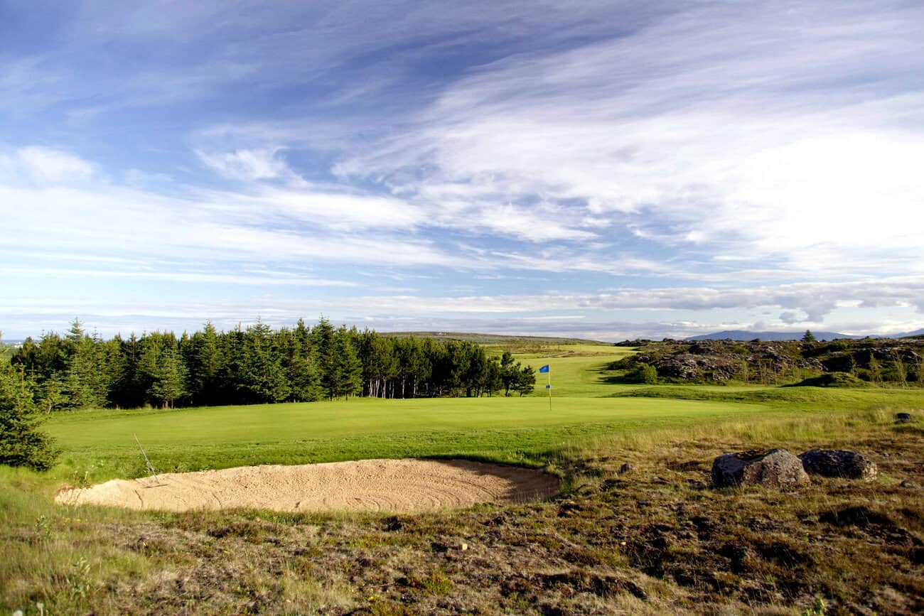 Golf course with sand trap and trees