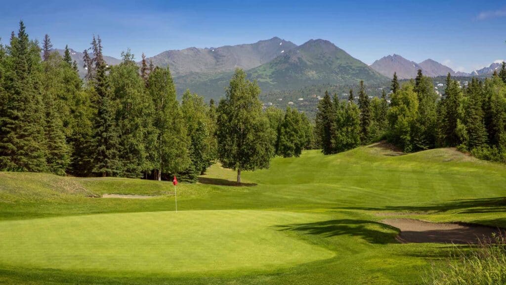 Lush green golf course with mountains