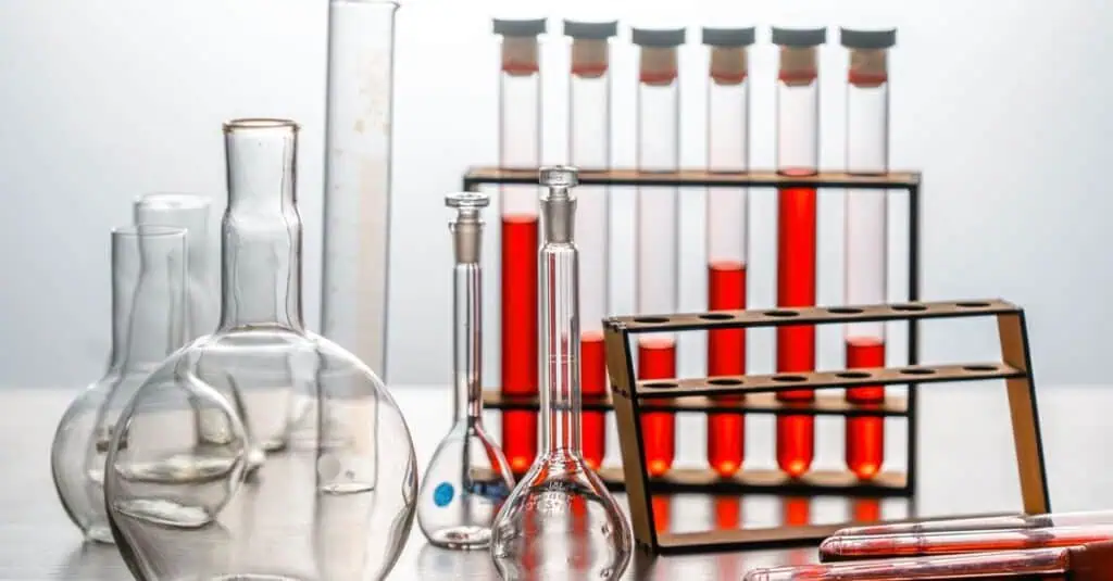 Scientific laboratory with test tubes, beakers, and glassware used for chemical analysis and research in health and nutrition.