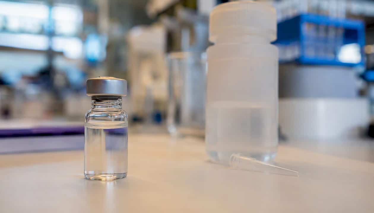 Peptide vial and PEGylation reagent on lab bench