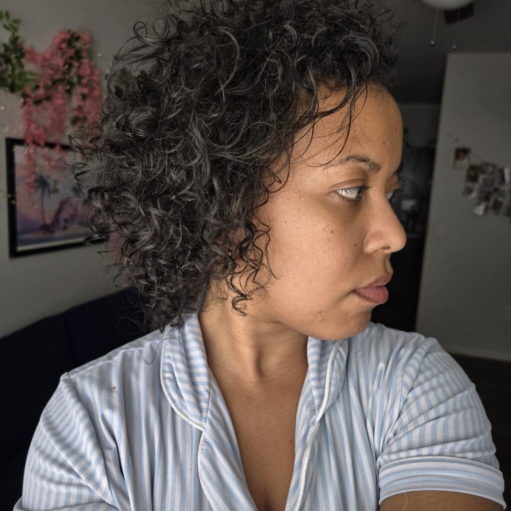 Close-up of curl pattern recovery during postpartum hair regrowth.