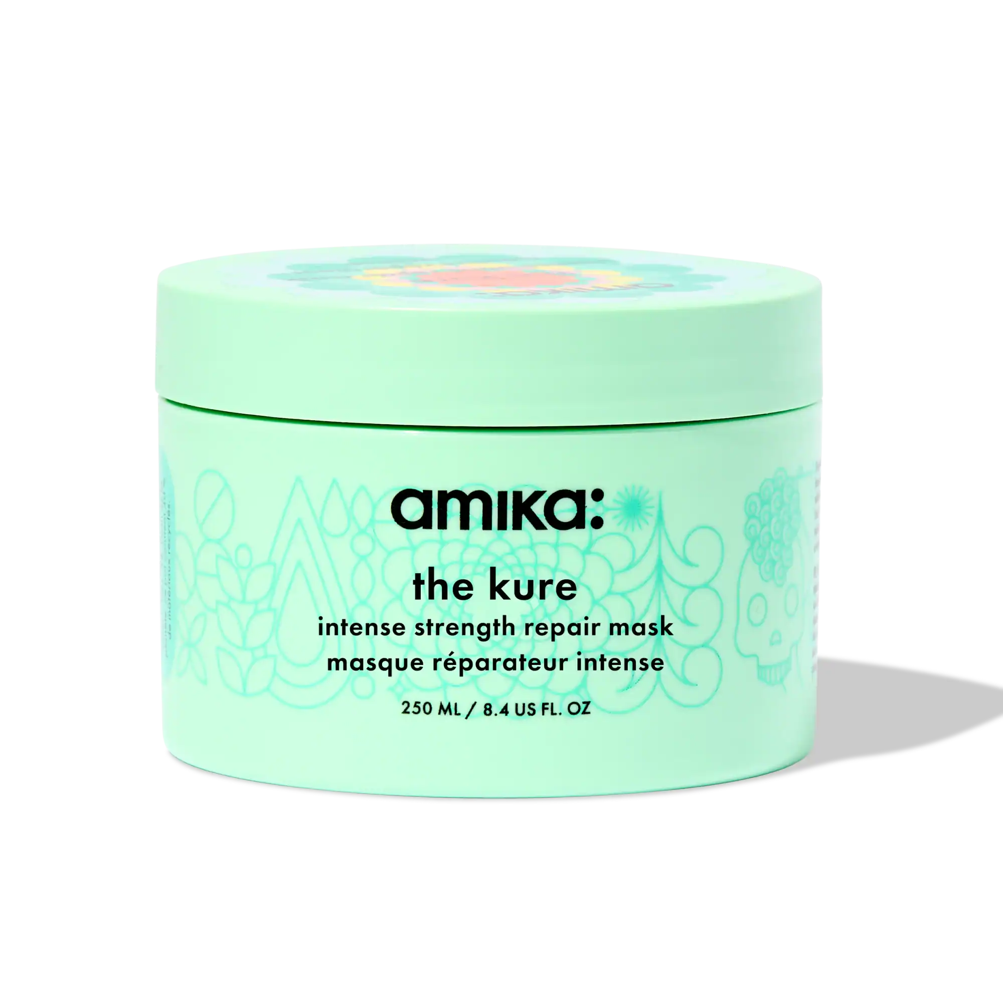 Pale mint jar of Amika The Kure Mask, formulated with bond cure technology to reverse chemical damage and restore elasticity.