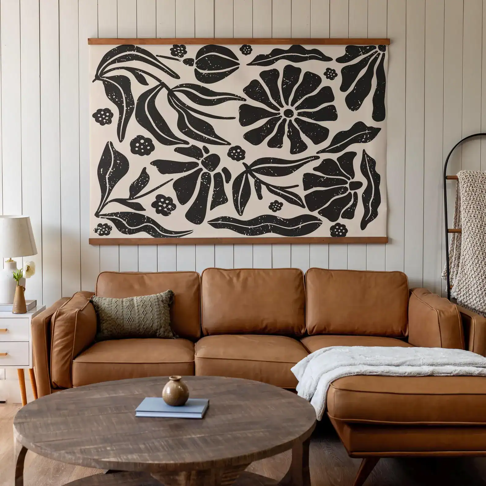 Extra-large boho tapestry wall art in soft earth tones, styled in a bright, minimalist room with neutral furniture and indoor plants. Lightweight and toddler-friendly.