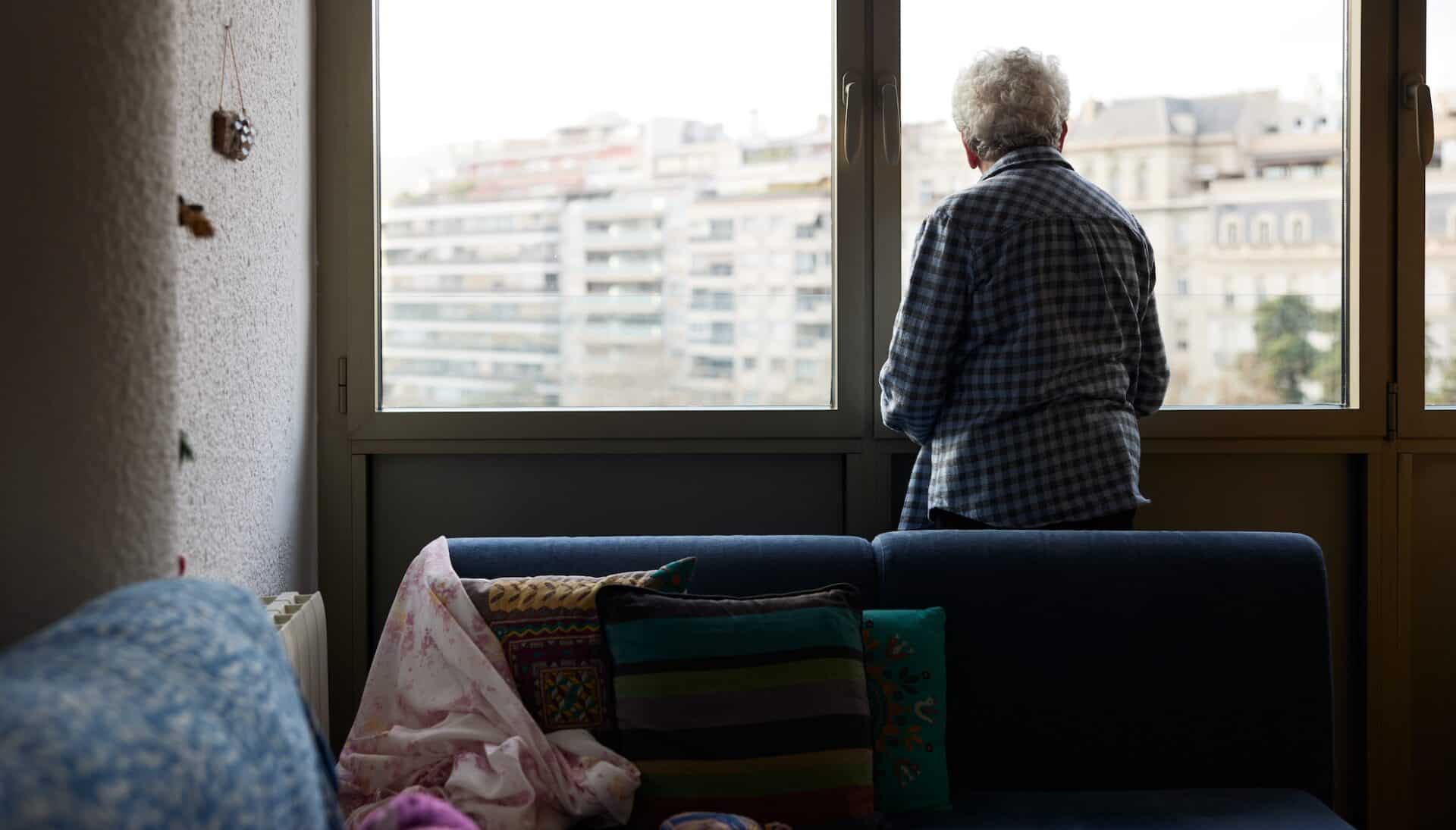 One senior woman looking out the window.