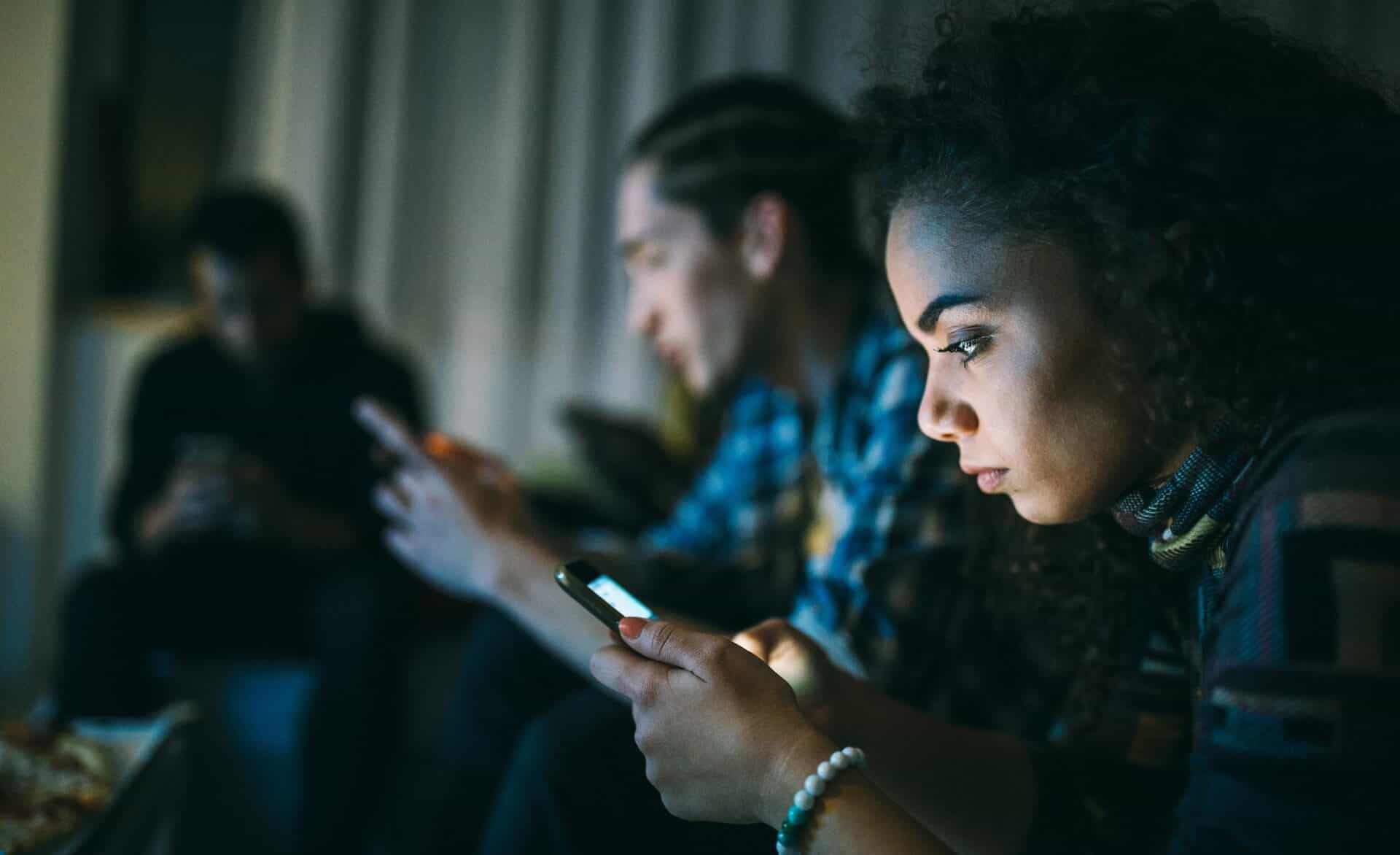 Multi ethnic group of friends using smart phones
