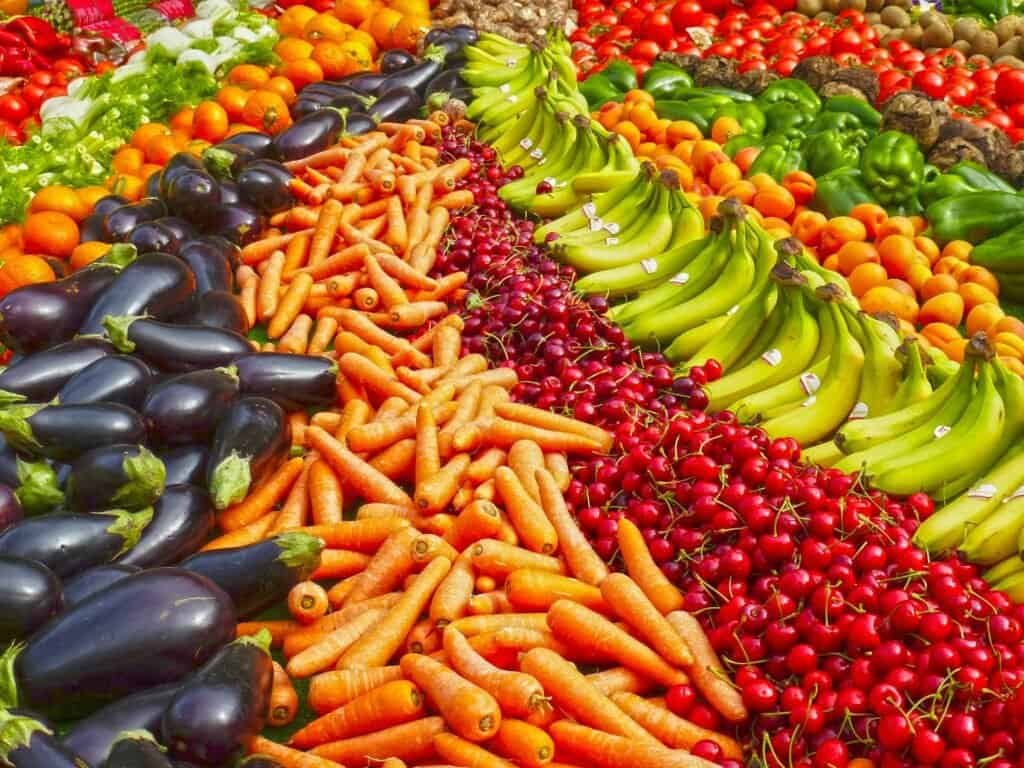 Vibrant selection of fresh fruits and vegetables on a market stall. Healthy eating and organic living.