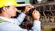 male electrician testing industrial machine