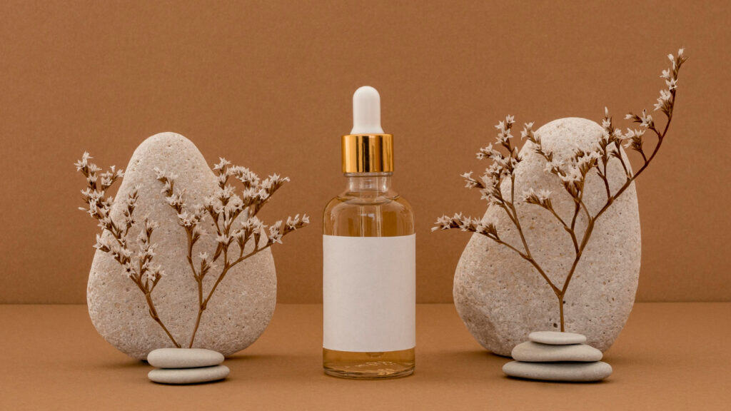 AIC antiseptic serum bottle with natural stones and dried flowers for skin care.