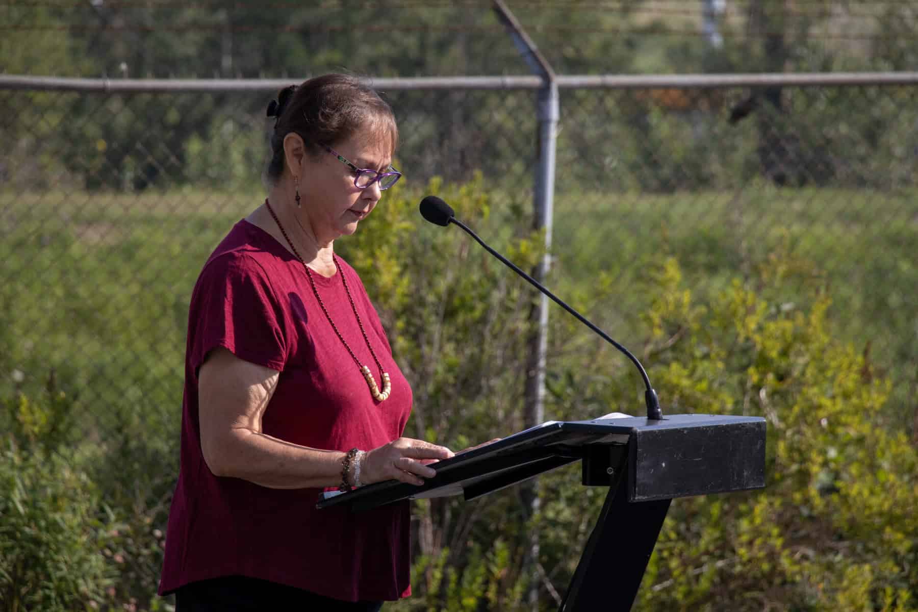 Members of the Arbios team and Lheidli T’enneh First Nation name the facility Chuntoh Ghuna on a microphone and podium