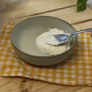 Smooth and creamy mascarpone cheese being worked with a spoon, the perfect base for an easy strawberry tiramisu recipe.