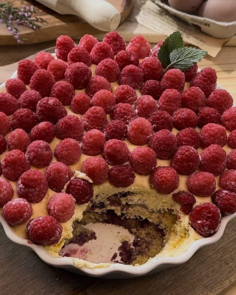 Homemade raspberry tiramisu, layered with soft biscuit, mascarpone cream, raspberry jam and fresh raspberries, creating a sweet and tangy twist on the classic dessert