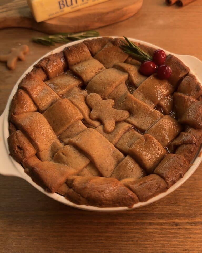 Delicious Gingerbread Apple Pie with Cranberries, featuring a festive gingerbread cookie dough crust and a cozy spiced apple pie filling with cranberries on top to decorate, perfect for the holidays