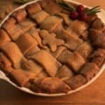 Delicious Gingerbread Apple Pie with Cranberries, featuring a festive gingerbread cookie dough crust and a cozy spiced apple pie filling with cranberries on top to decorate, perfect for the holidays