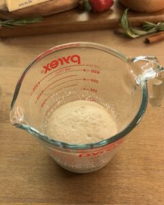 Mixing dry yeast, warm water, and sugar to make the sponge for Nutella-stuffed brioche