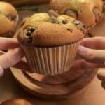 Freshly baked cookie dough muffins with chocolate chunks, showcasing a gooey and rich texture