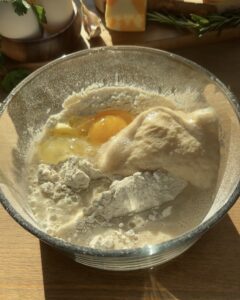 Mixing all-purpose flour, salt, milk, egg, soft butter, and the yeast mixture in a bowl to create the dough for the Jellycat croissant