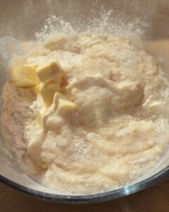 All dough ingredients in a bowl, ready to be kneaded into a smooth, elastic dough for a perfect bread texture