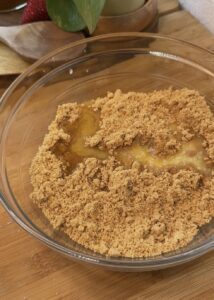 No-bake pistachio cheesecake crust made with broken biscuits and melted butter, ready for the creamy pistachio filling